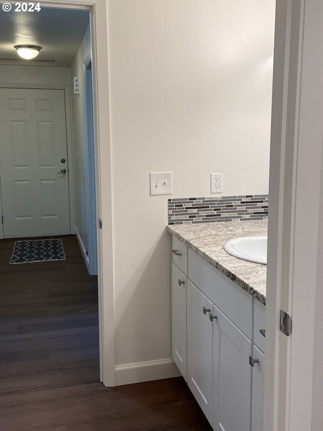 bathroom featuring tasteful backsplash, vanity, and hardwood / wood-style flooring