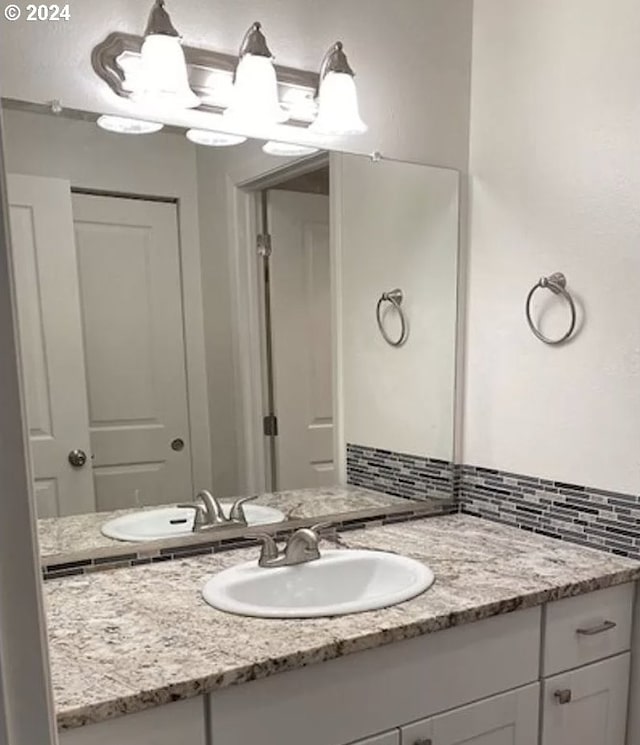 bathroom with vanity and backsplash