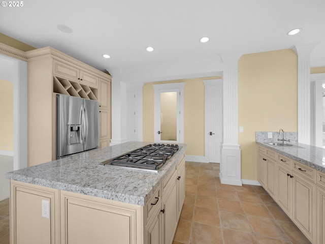 88902 Pinehurst Rd, Gearhart, OR 97138 - kitchen with cream cabinetry, appliances with stainless steel finishes, a sink, light stone countertops, and recessed lighting