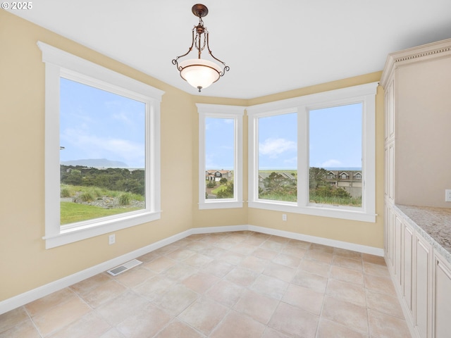 88902 Pinehurst Rd, Gearhart, OR 97138 - unfurnished dining area with healthy amount of natural light and baseboards