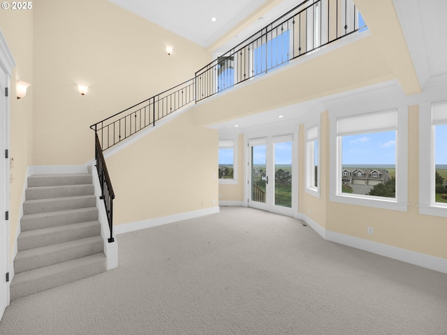 88902 Pinehurst Rd, Gearhart, OR 97138 - unfurnished living room with baseboards, carpet floors, stairs, a high ceiling, and recessed lighting