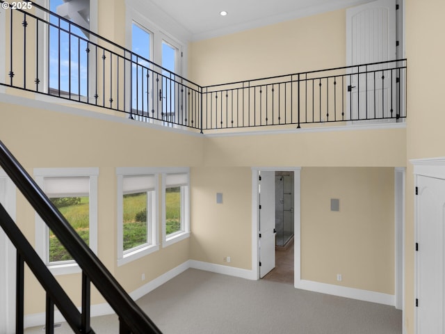 88902 Pinehurst Rd, Gearhart, OR 97138 - stairs with carpet floors, a high ceiling, baseboards, and recessed lighting
