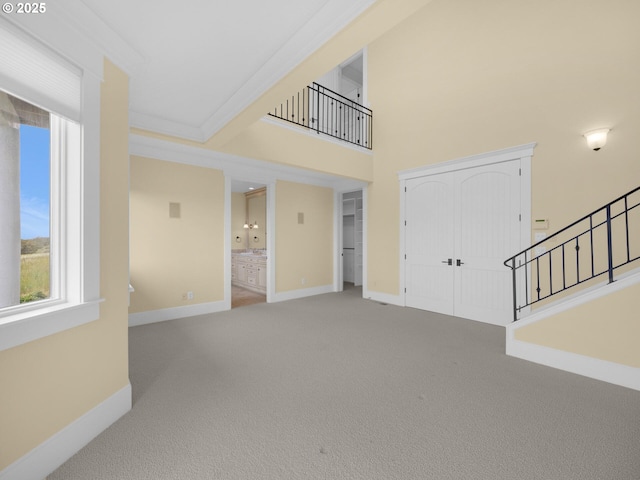 88902 Pinehurst Rd, Gearhart, OR 97138 - unfurnished living room featuring stairway, carpet, and baseboards