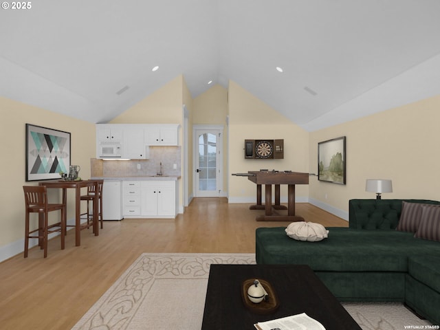 88902 Pinehurst Rd, Gearhart, OR 97138 - living room featuring light wood-type flooring, high vaulted ceiling, and baseboards