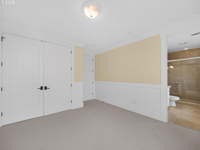 88902 Pinehurst Rd, Gearhart, OR 97138 - unfurnished bedroom featuring carpet flooring, a wainscoted wall, a closet, and connected bathroom