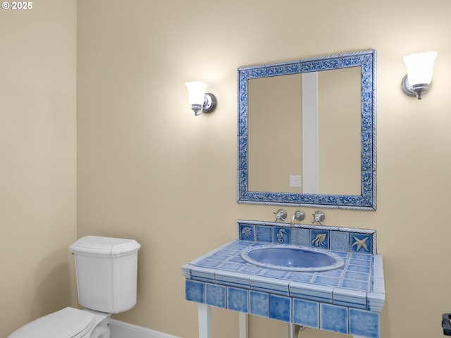 88902 Pinehurst Rd, Gearhart, OR 97138 - half bath featuring toilet, a sink, and baseboards