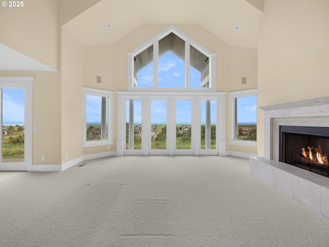 88902 Pinehurst Rd, Gearhart, OR 97138 - unfurnished living room featuring high vaulted ceiling, a high end fireplace, carpet flooring, and baseboards