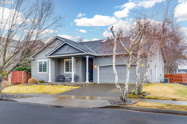 view of front of house with central AC, a front yard, fence, and driveway