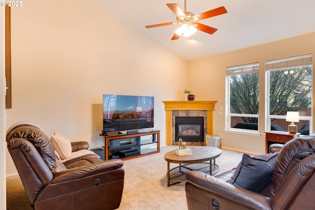 carpeted living area featuring a ceiling fan, lofted ceiling, baseboards, and a tiled fireplace