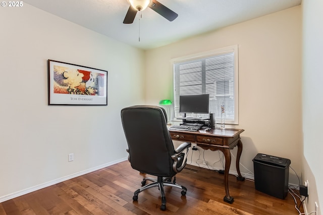 office space featuring baseboards, wood finished floors, and ceiling fan