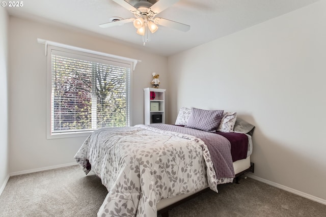 bedroom featuring ceiling fan, baseboards, and carpet