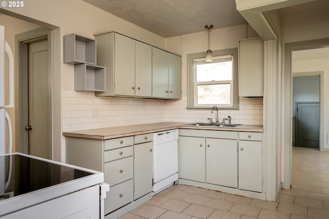 kitchen with white cabinets, dishwasher, decorative backsplash, sink, and hanging light fixtures