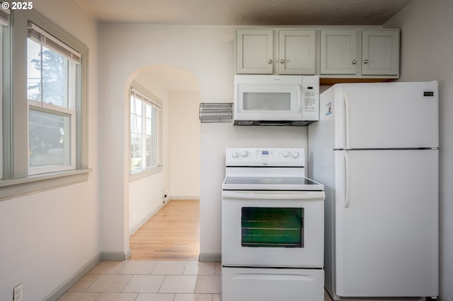 kitchen with white appliances and light tile patterned floors