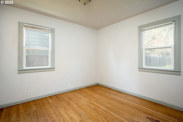 unfurnished room with light hardwood / wood-style flooring