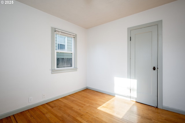 spare room with hardwood / wood-style flooring