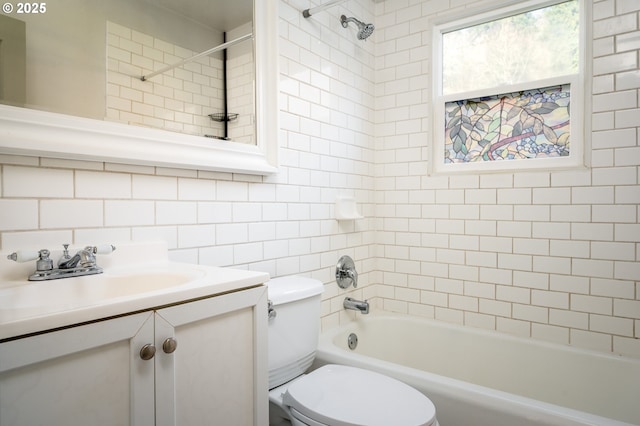 full bathroom featuring tiled shower / bath combo, toilet, decorative backsplash, and vanity