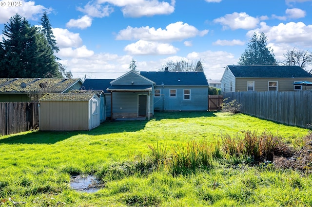 rear view of house with a storage unit and a lawn