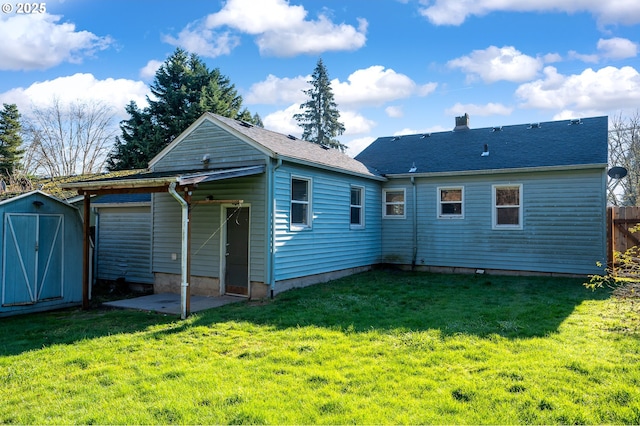 rear view of house featuring a storage shed and a lawn