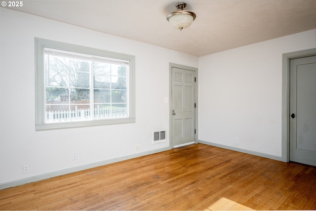 spare room with light wood-type flooring