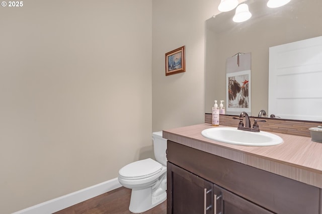 8070 SW 195th Ave, Beaverton, OR 97007 - bathroom featuring vanity, toilet, baseboards, and wood finished floors