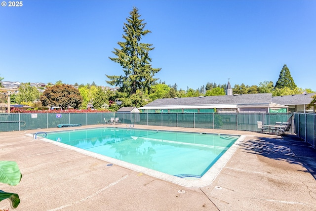 community pool featuring fence and a patio area