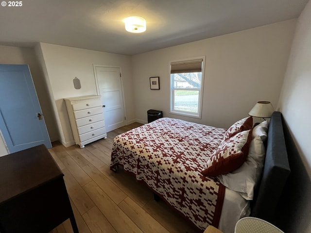 bedroom featuring wood finished floors and baseboards