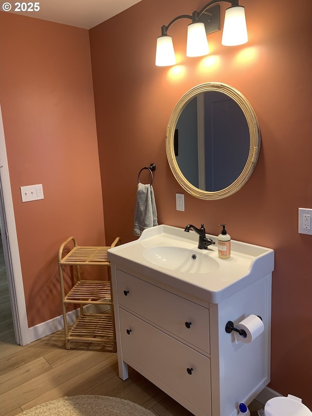 bathroom featuring wood finished floors and vanity