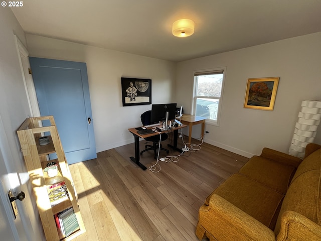 office area with baseboards and wood finished floors
