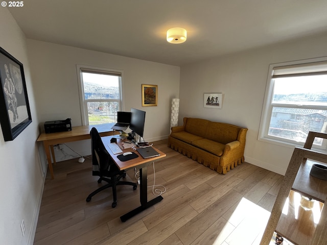 office featuring light wood-style flooring and baseboards