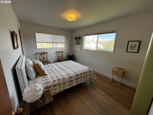 bedroom featuring baseboards and wood finished floors
