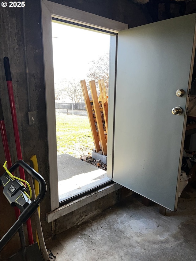 doorway featuring unfinished concrete flooring