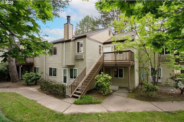 12062 SW Conestoga Dr, Beaverton, OR 97008 - back of house featuring a chimney and stairway