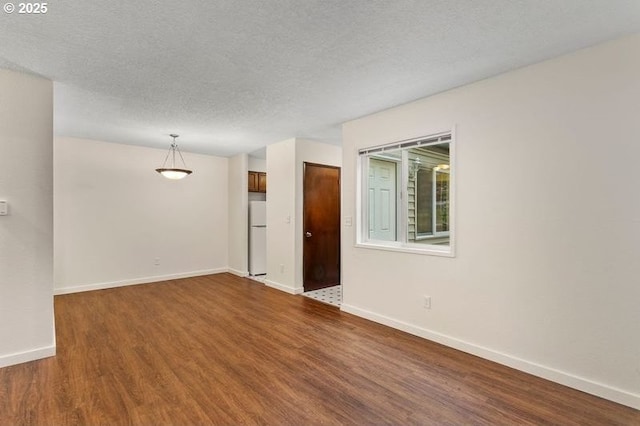 12062 SW Conestoga Dr, Beaverton, OR 97008 - unfurnished room featuring wood finished floors, baseboards, and a textured ceiling