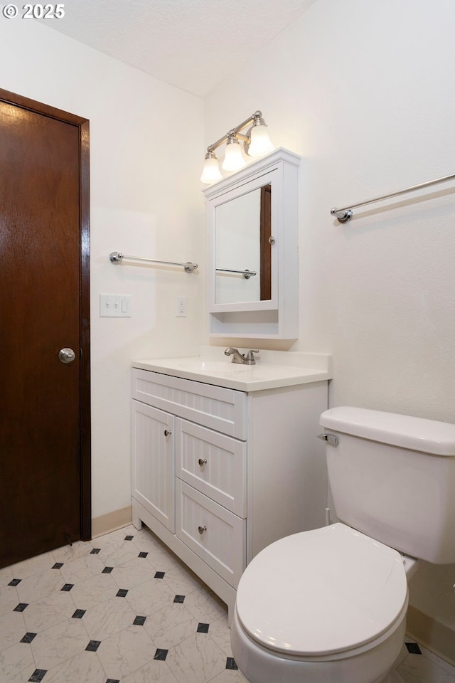 12062 SW Conestoga Dr, Beaverton, OR 97008 - bathroom featuring vanity, toilet, and baseboards