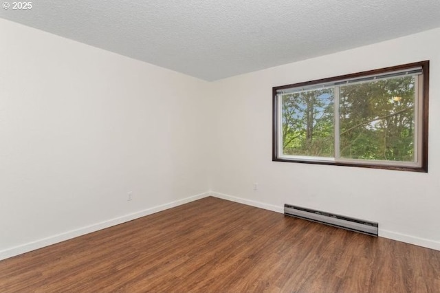 12062 SW Conestoga Dr, Beaverton, OR 97008 - empty room with baseboard heating, wood finished floors, baseboards, and a textured ceiling