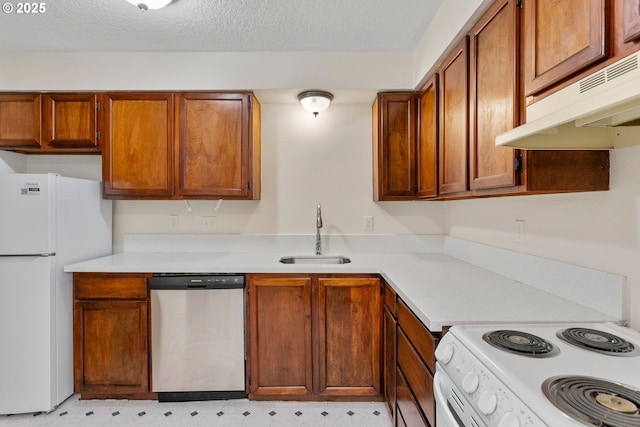 12062 SW Conestoga Dr, Beaverton, OR 97008 - kitchen featuring white appliances, a sink, light flooring, under cabinet range hood, and light countertops