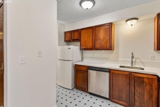 12062 SW Conestoga Dr, Beaverton, OR 97008 - kitchen featuring dishwasher, freestanding refrigerator, a sink, light flooring, and light countertops