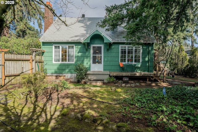 view of front of home with fence and a chimney