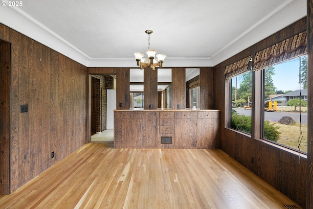 107 NW 10th Ave, Canby, OR 97013 - unfurnished dining area with wooden walls, a chandelier, and wood finished floors