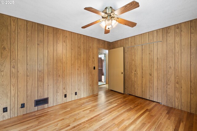 107 NW 10th Ave, Canby, OR 97013 - spare room with wood walls, wood finished floors, and ceiling fan