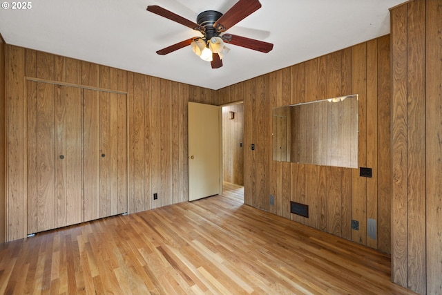 107 NW 10th Ave, Canby, OR 97013 - unfurnished bedroom with wood finished floors, wood walls, a closet, and a ceiling fan