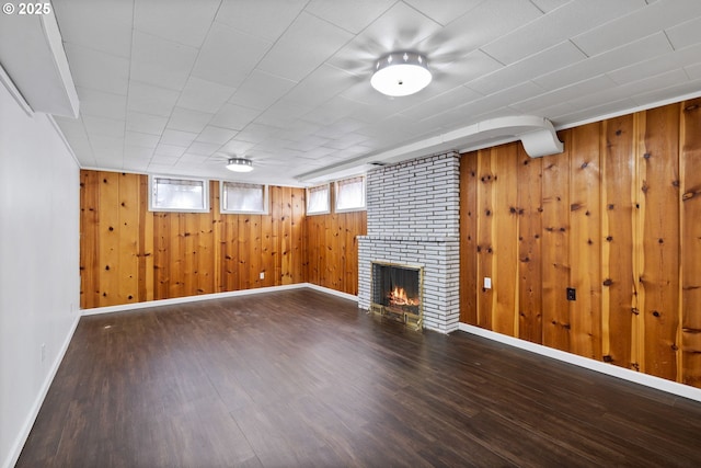 107 NW 10th Ave, Canby, OR 97013 - below grade area with wood finished floors, wooden walls, and a fireplace