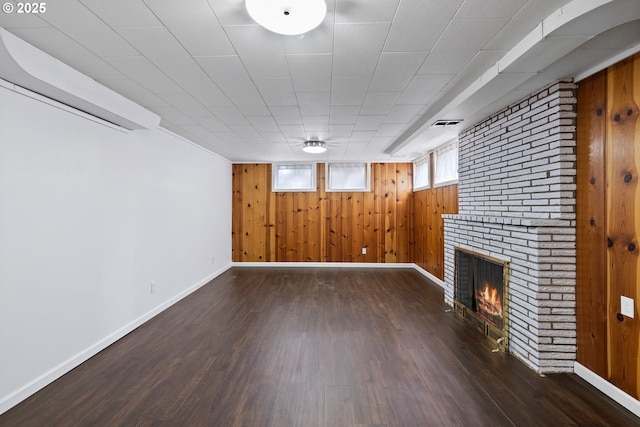 107 NW 10th Ave, Canby, OR 97013 - basement featuring wooden walls, wood finished floors, and a brick fireplace