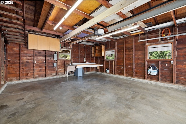 107 NW 10th Ave, Canby, OR 97013 - garage featuring a garage door opener and wood walls
