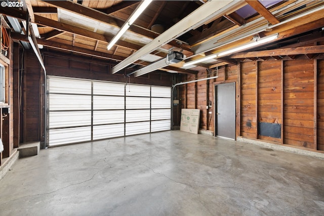 107 NW 10th Ave, Canby, OR 97013 - garage featuring wooden walls and a garage door opener