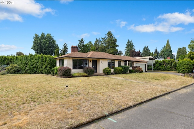 107 NW 10th Ave, Canby, OR 97013 - single story home featuring an attached garage, asphalt driveway, a chimney, and a front yard