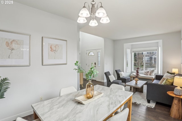 dining room with dark hardwood / wood-style flooring and an inviting chandelier