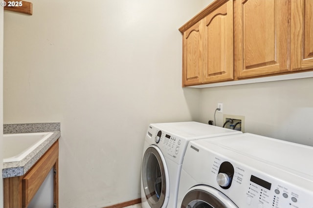 laundry room featuring sink, independent washer and dryer, and cabinets