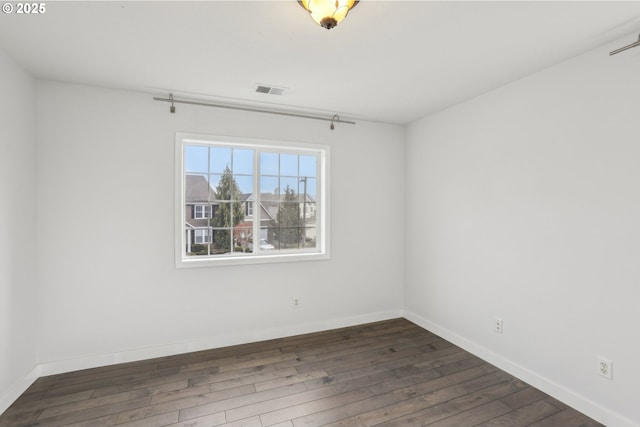 unfurnished room with dark hardwood / wood-style flooring