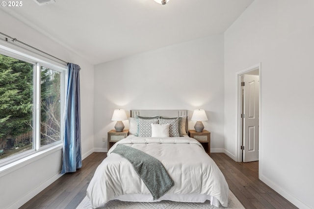 bedroom with dark hardwood / wood-style floors